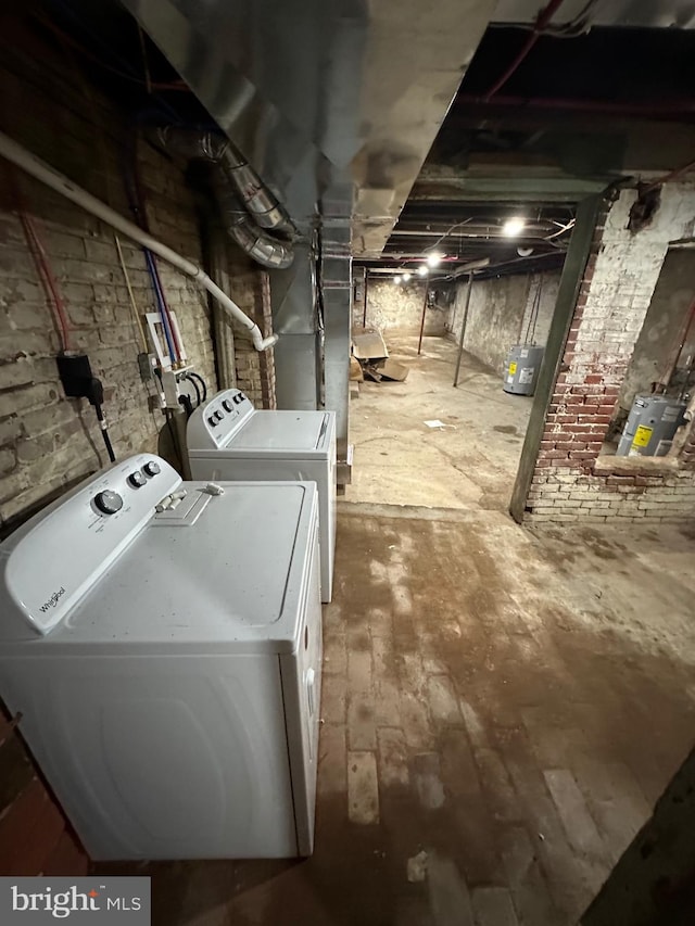 laundry area featuring wood-type flooring and washing machine and dryer