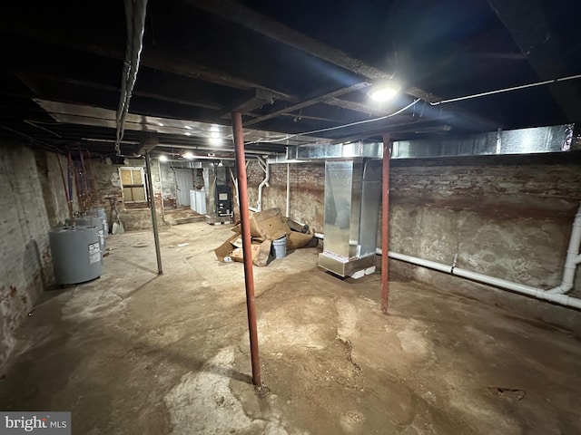 basement featuring water heater and heating unit