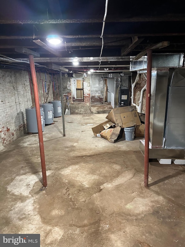 basement featuring heating unit, water heater, and electric water heater