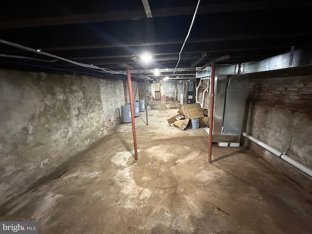 basement with electric panel and heating unit