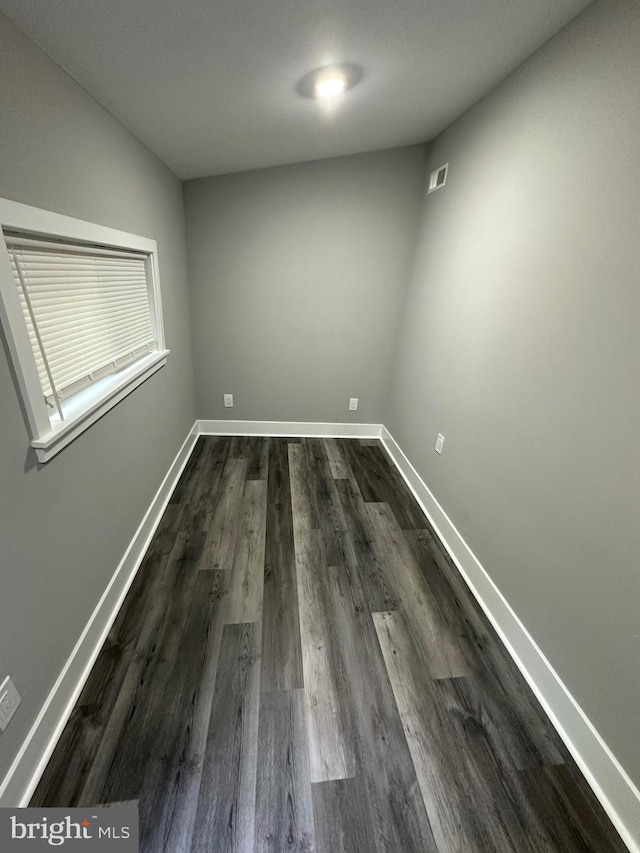 spare room featuring dark hardwood / wood-style floors