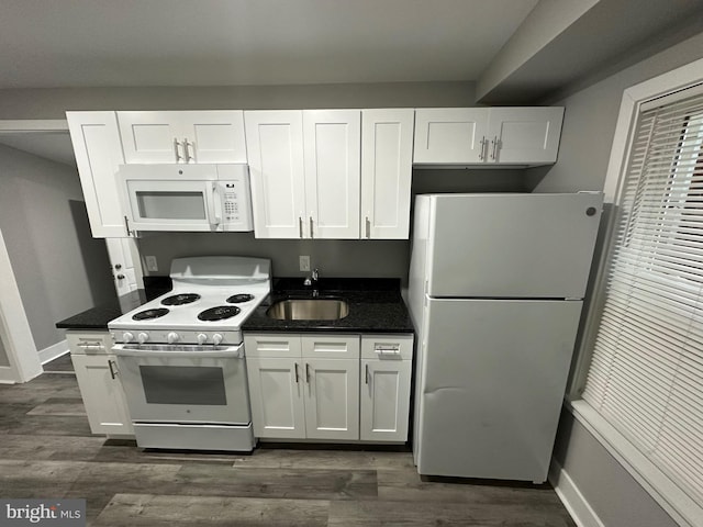 kitchen with white appliances and white cabinetry