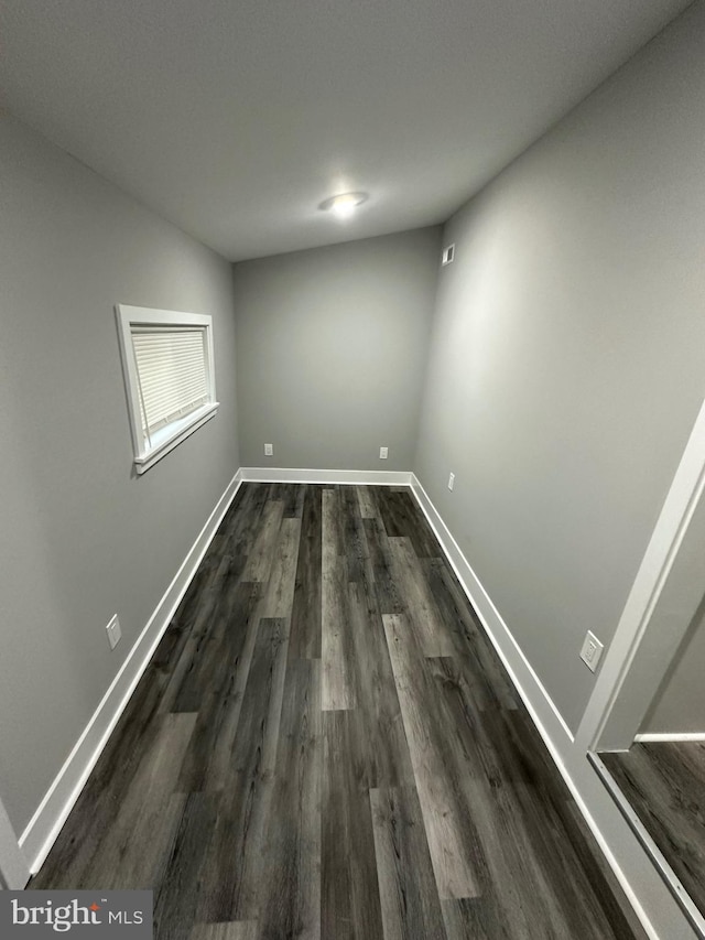 unfurnished room with dark hardwood / wood-style flooring