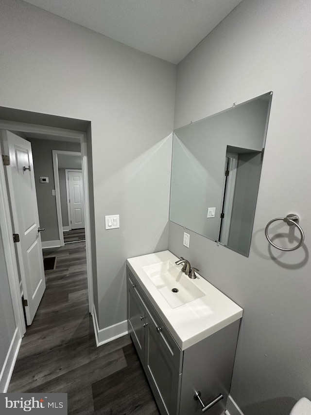 bathroom with hardwood / wood-style floors and vanity