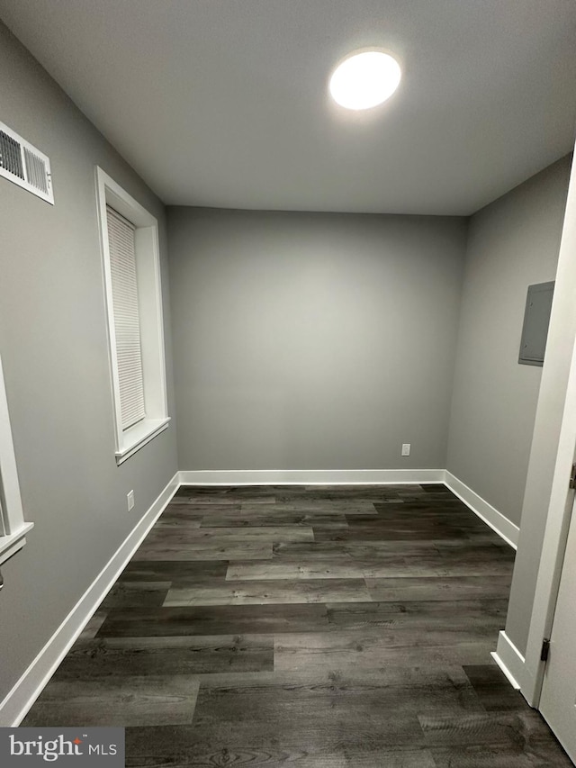 spare room with dark wood-type flooring