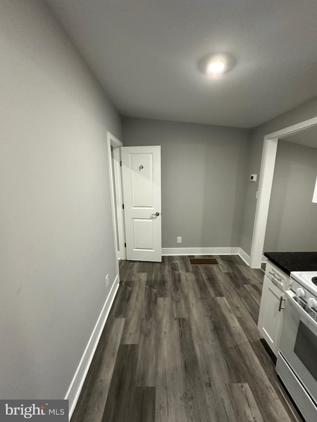 hallway featuring dark hardwood / wood-style flooring