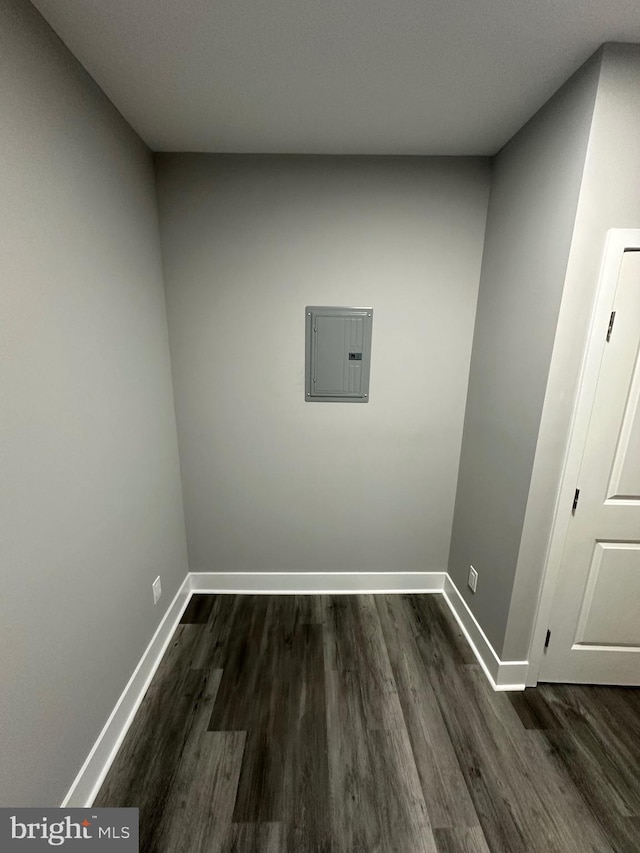 laundry room with electric panel and dark wood-type flooring