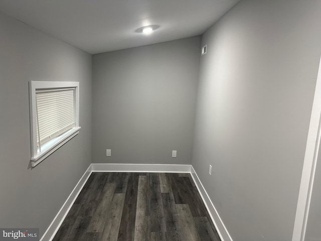 spare room with dark hardwood / wood-style floors