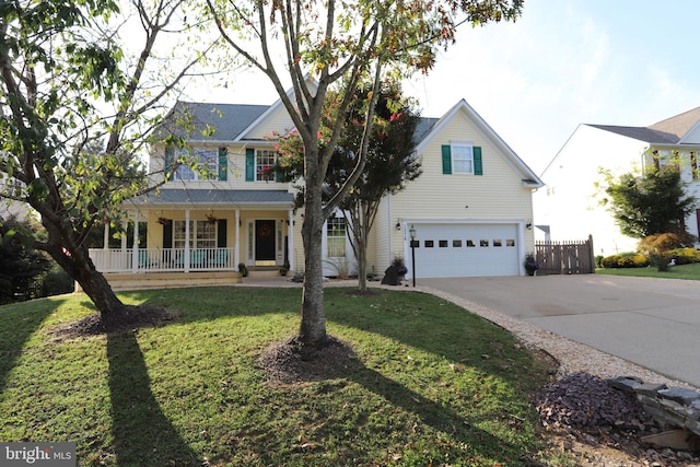 view of front of home with a garage, a porch, and a front lawn