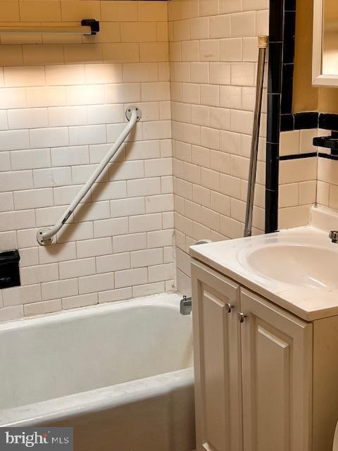 bathroom with vanity and a tub