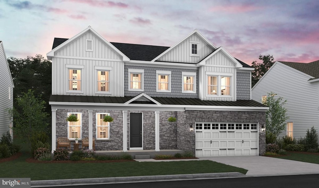 view of front of home with a lawn and a garage