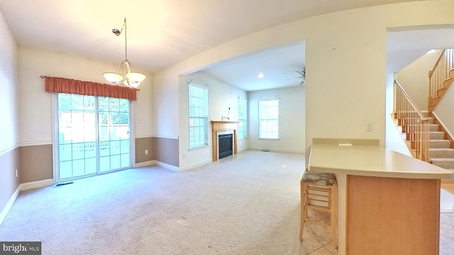 107 Sequoia Dr, Berlin, NJ 08009 - unfurnished living room featuring stairway, light colored carpet, a chandelier, a fireplace with flush hearth, and ceiling fan
