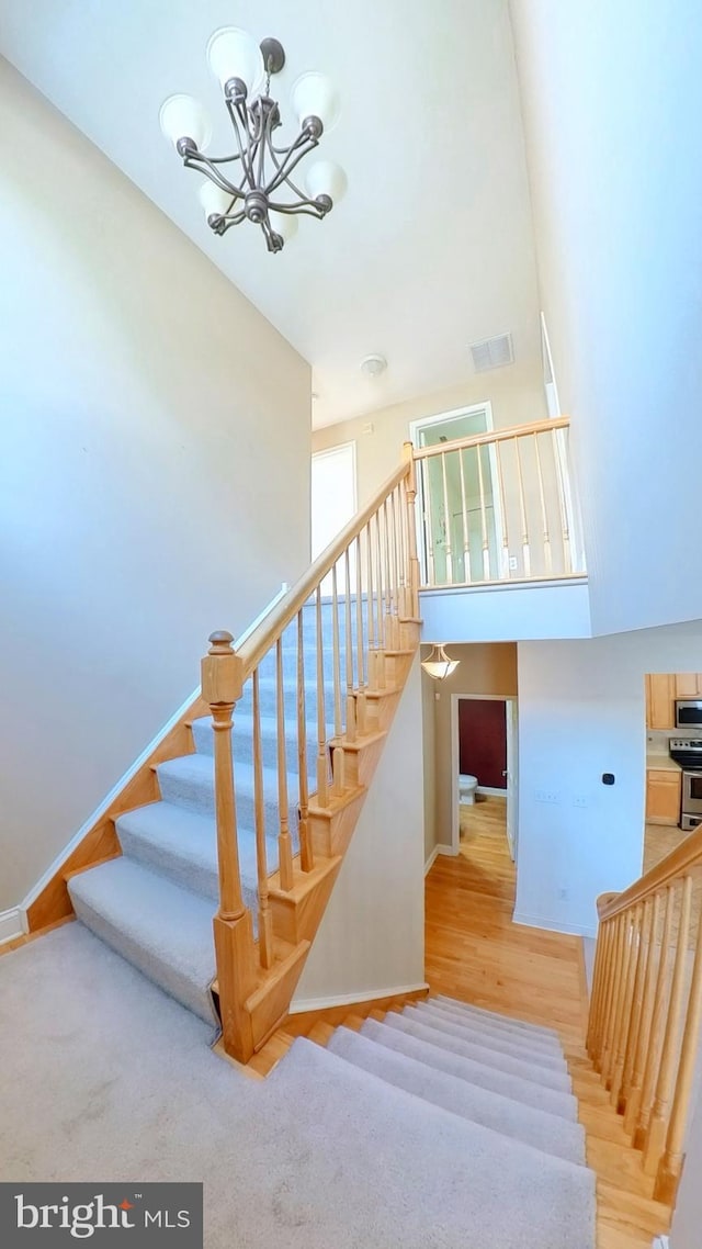 107 Sequoia Dr, Berlin, NJ 08009 - staircase featuring wood finished floors, a chandelier, and a towering ceiling