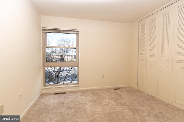 unfurnished bedroom featuring light colored carpet