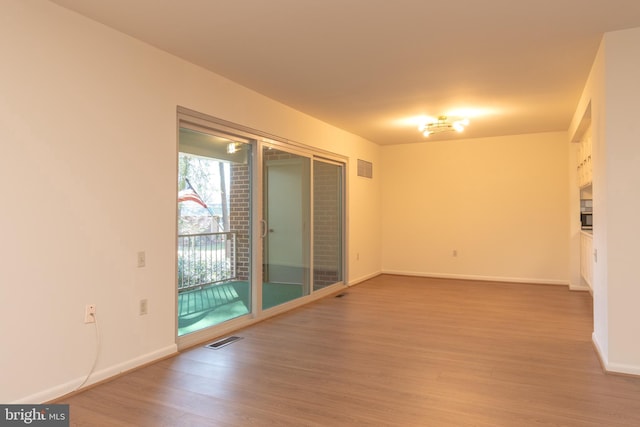 unfurnished room with light hardwood / wood-style flooring