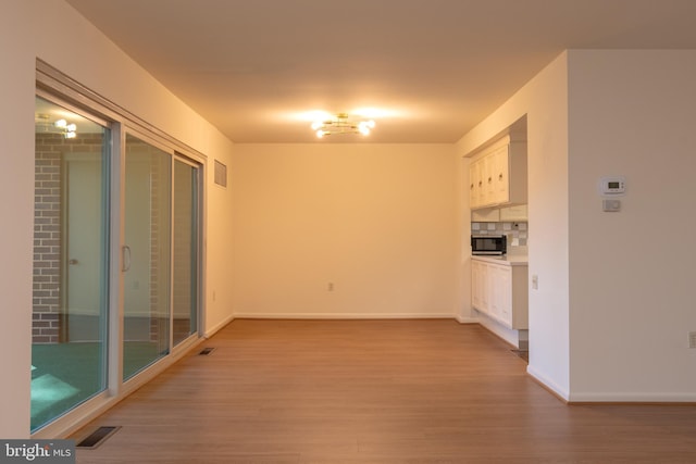 unfurnished living room with light hardwood / wood-style floors