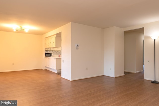 unfurnished living room with wood-type flooring