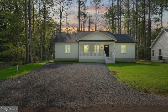 view of front of house featuring a lawn and covered porch