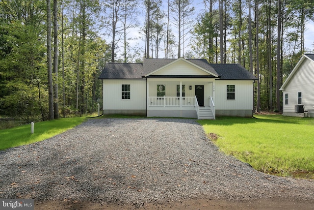 view of front of home featuring covered porch, a front yard, and central air condition unit