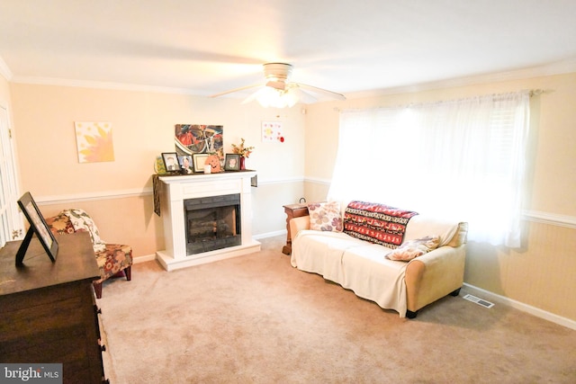 carpeted living room featuring crown molding and ceiling fan