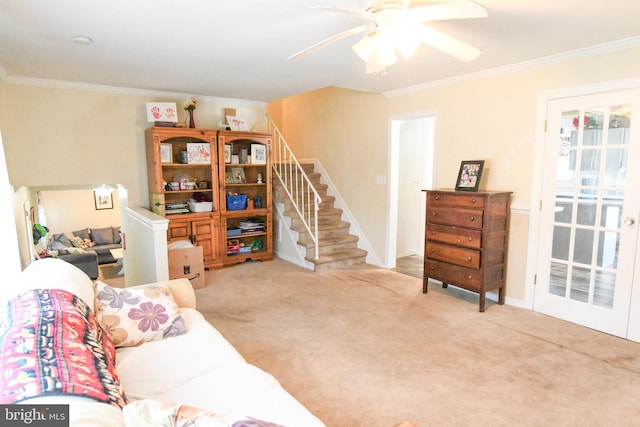 carpeted living room with ornamental molding and ceiling fan