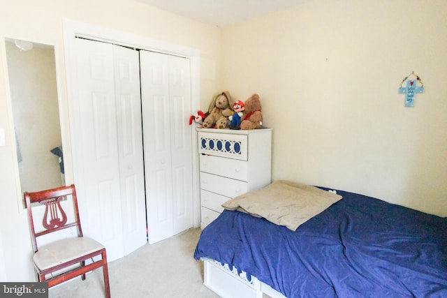 bedroom with a closet and light colored carpet