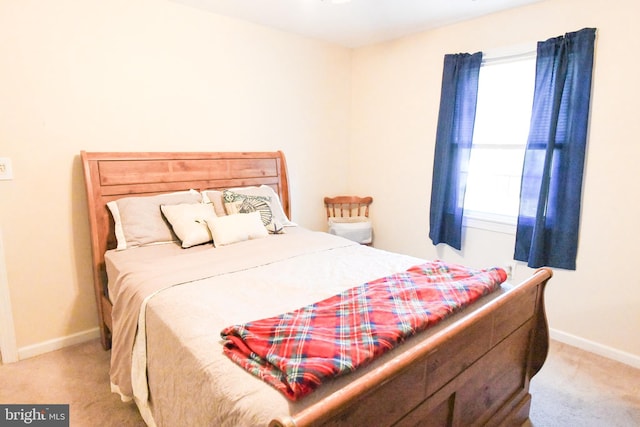 bedroom featuring light colored carpet