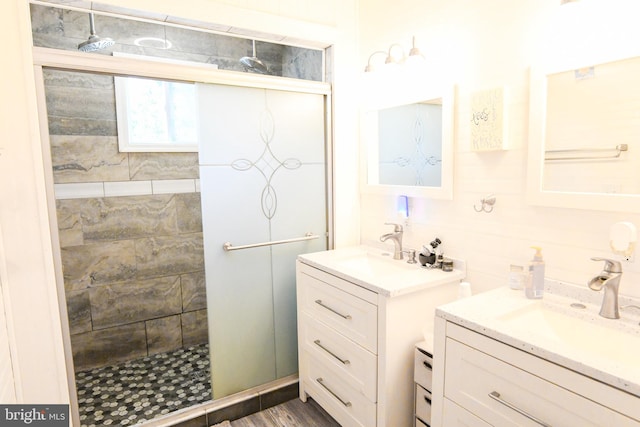 bathroom with vanity, an enclosed shower, and hardwood / wood-style flooring