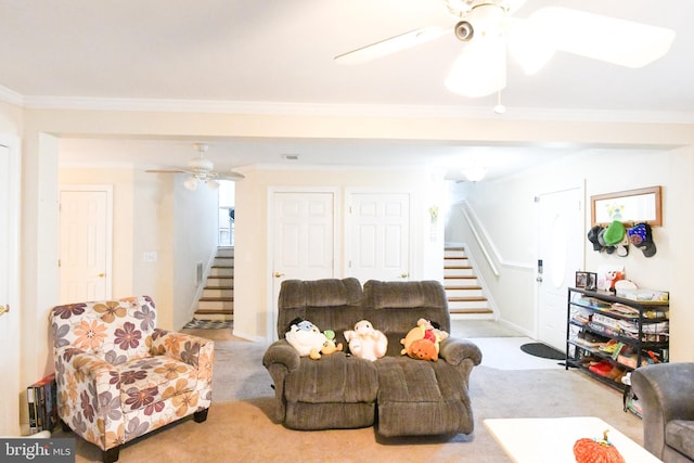 living room with light carpet, ornamental molding, and ceiling fan