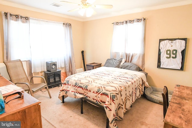 carpeted bedroom featuring crown molding and ceiling fan