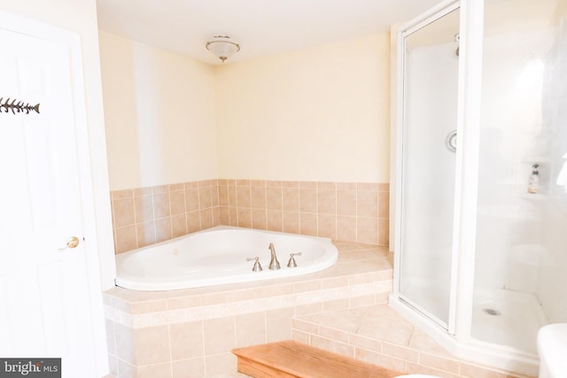 bathroom featuring separate shower and tub