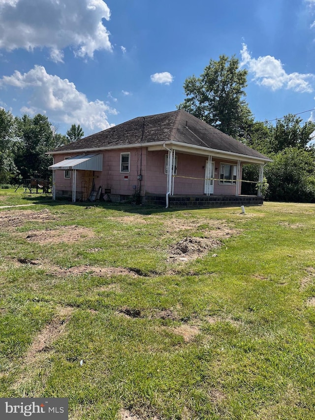 view of side of property with a yard