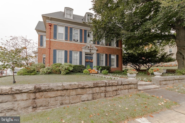 colonial home with a front lawn