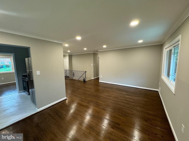 spare room with crown molding and dark hardwood / wood-style floors