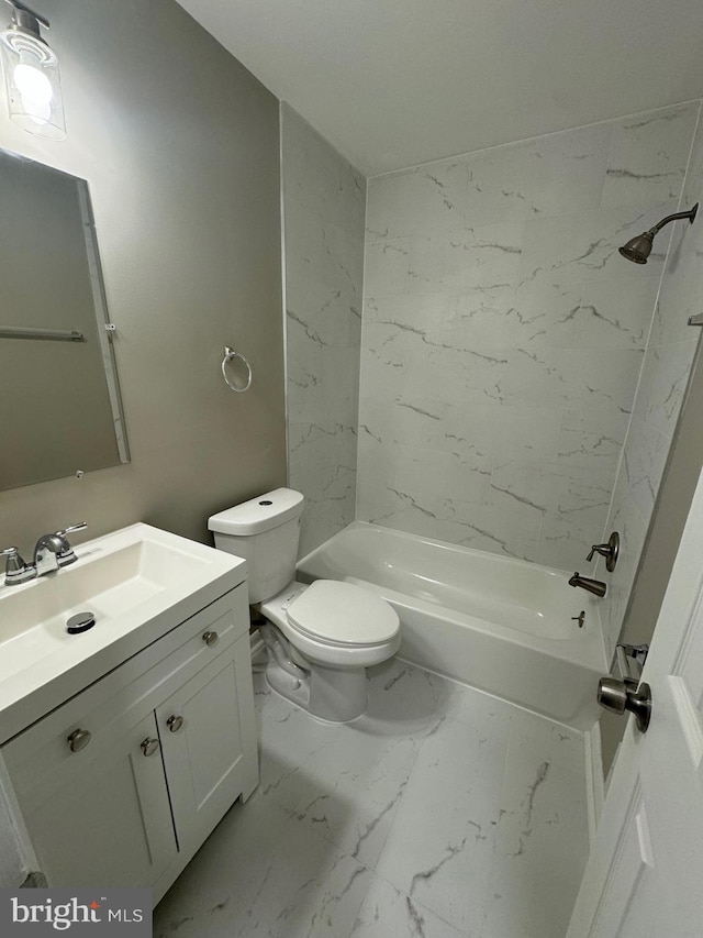 full bathroom featuring tiled shower / bath, vanity, and toilet