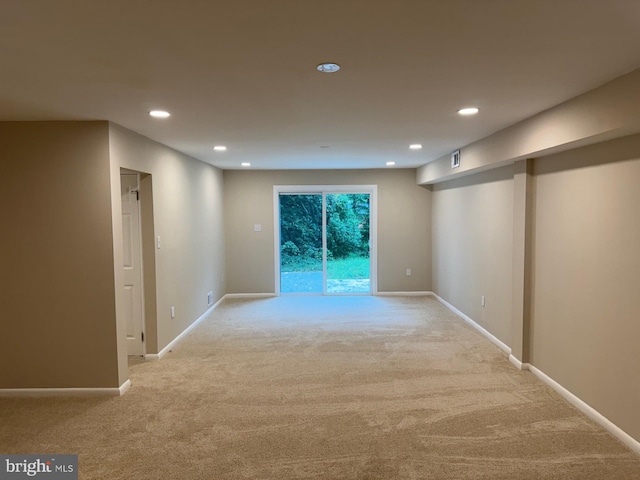 unfurnished room featuring light colored carpet