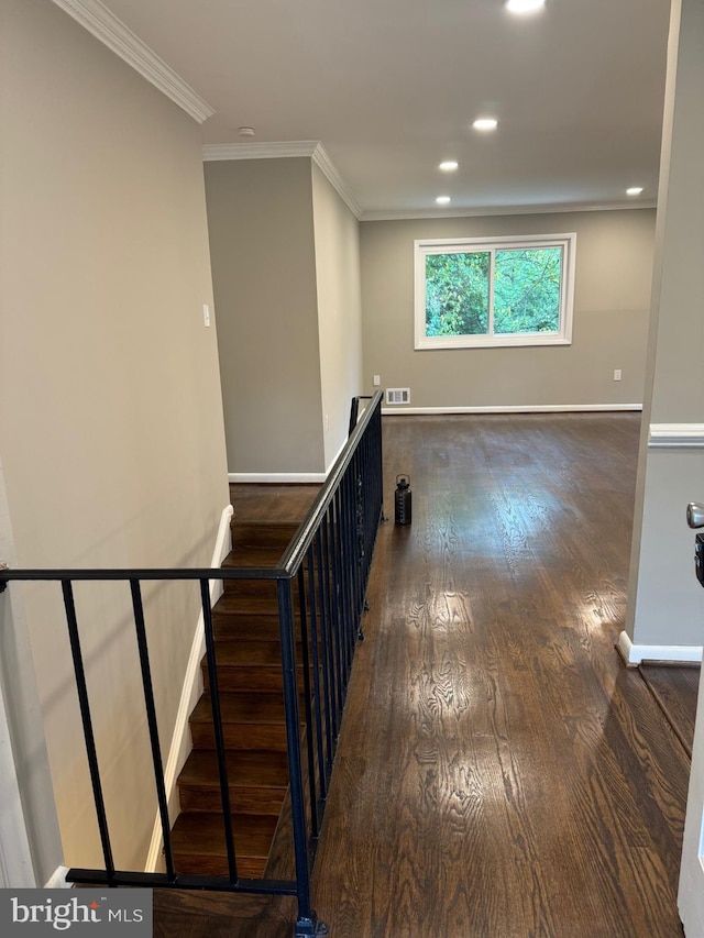 stairs featuring wood-type flooring and ornamental molding