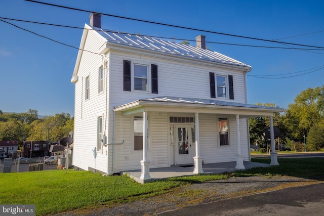 view of front of home featuring a front yard and a porch