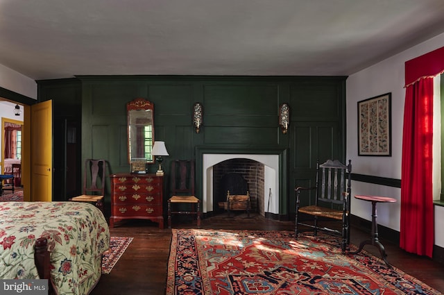 bedroom with dark hardwood / wood-style flooring