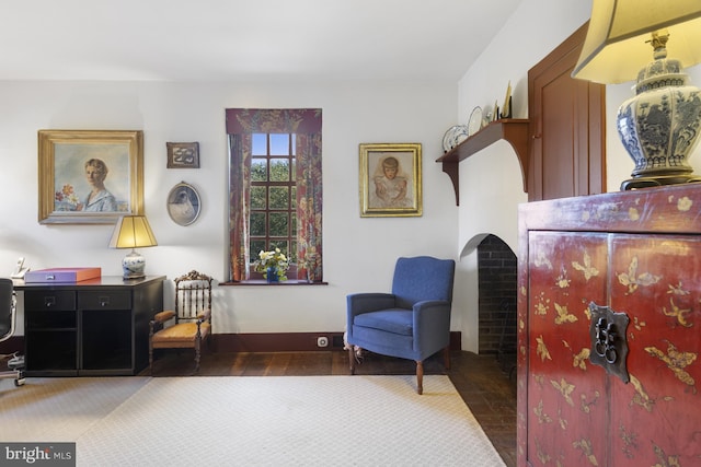 sitting room featuring dark colored carpet