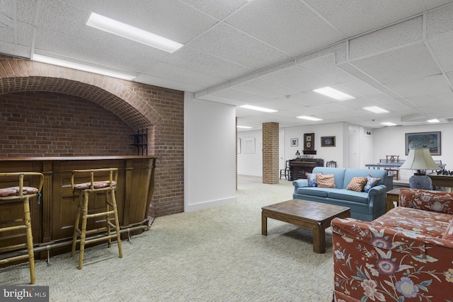 living room with a paneled ceiling, carpet flooring, and bar area