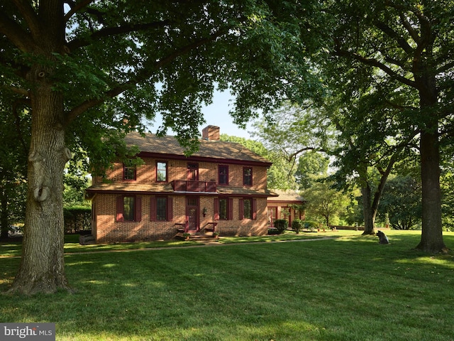 back of property featuring a lawn