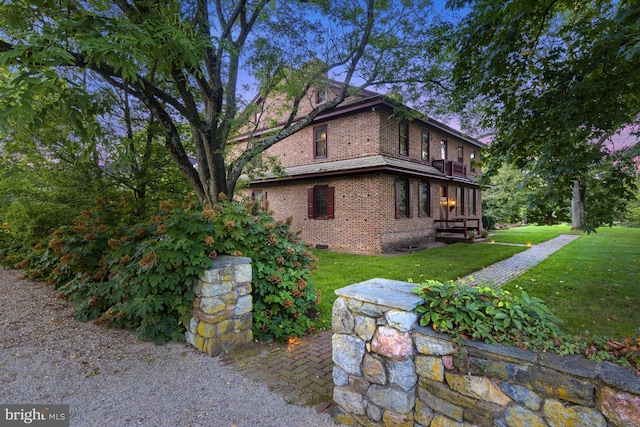 view of side of home featuring a lawn