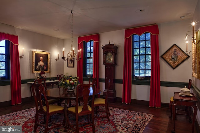 dining room with a notable chandelier and dark hardwood / wood-style flooring