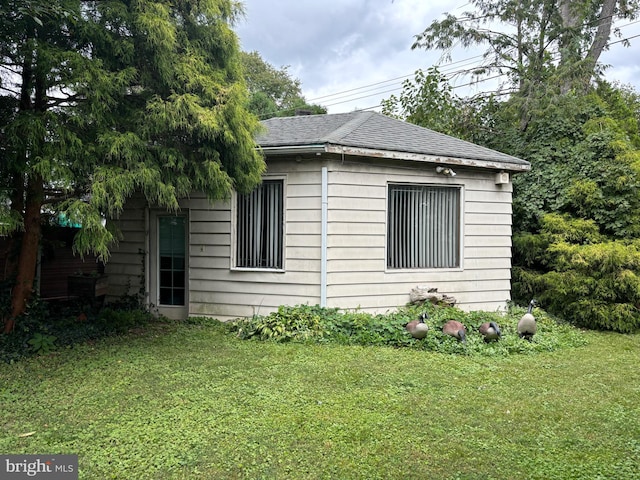 view of side of property with a yard