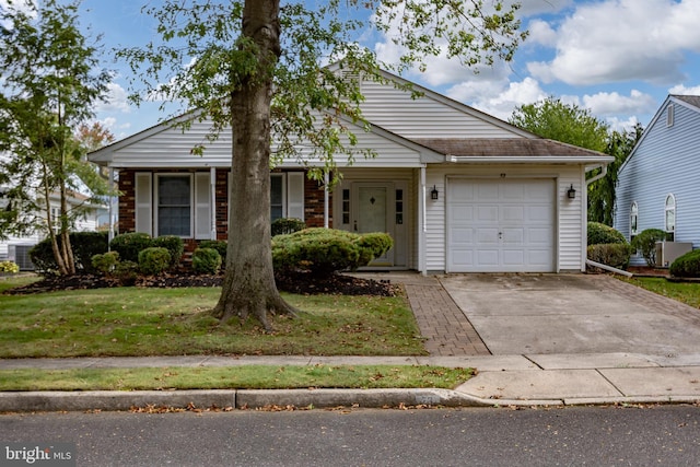 ranch-style house featuring a garage and a front lawn