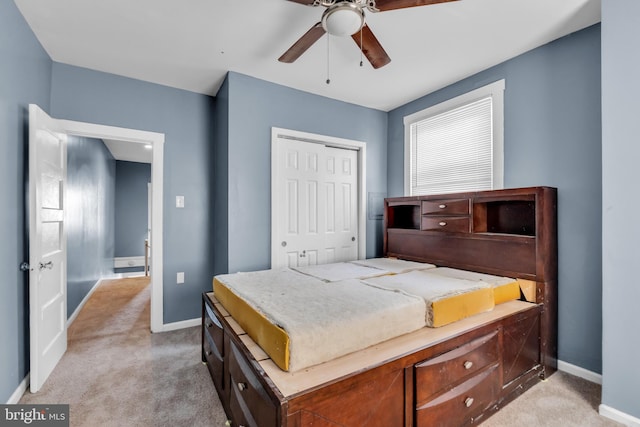 bedroom featuring ceiling fan, a closet, and light carpet