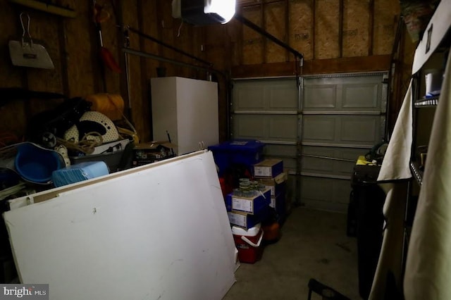 garage with a garage door opener and wooden walls