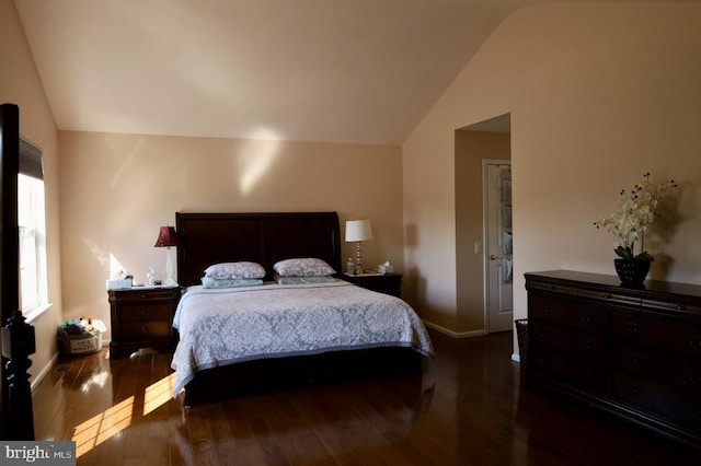 bedroom featuring lofted ceiling and dark hardwood / wood-style flooring