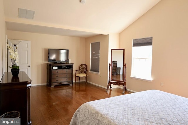 bedroom with vaulted ceiling and dark hardwood / wood-style flooring